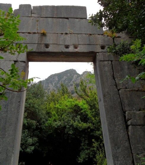 Color photo of an ancient temple with the Taurus mountains through the doorway
