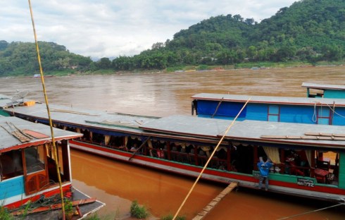 Color photo of a long boat on the Mekong River