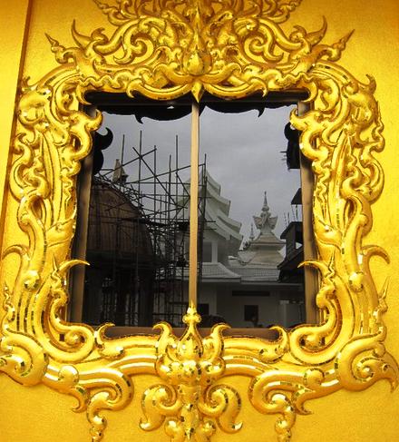 color photo at the golden temple reflection in a window