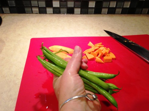 Cutting up sweet potato and green beans